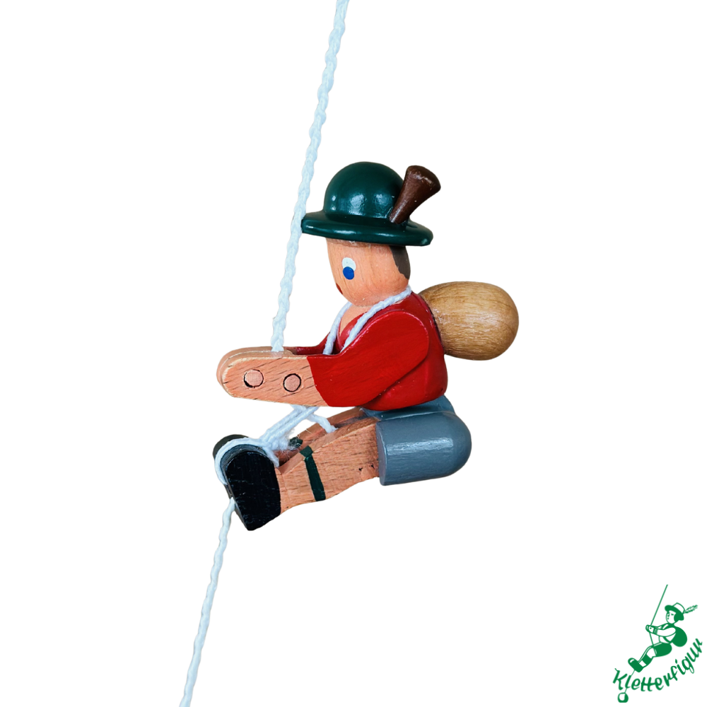 Climbing figurine mountaineer with red jacket