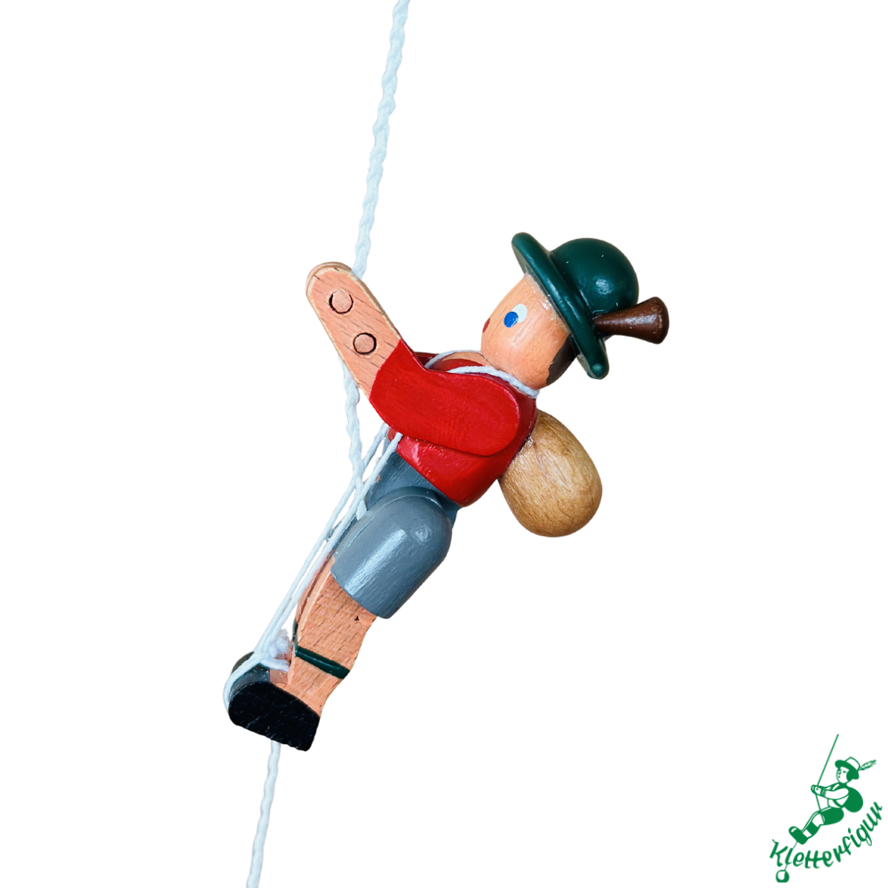 Climbing figurine mountaineer with red jacket